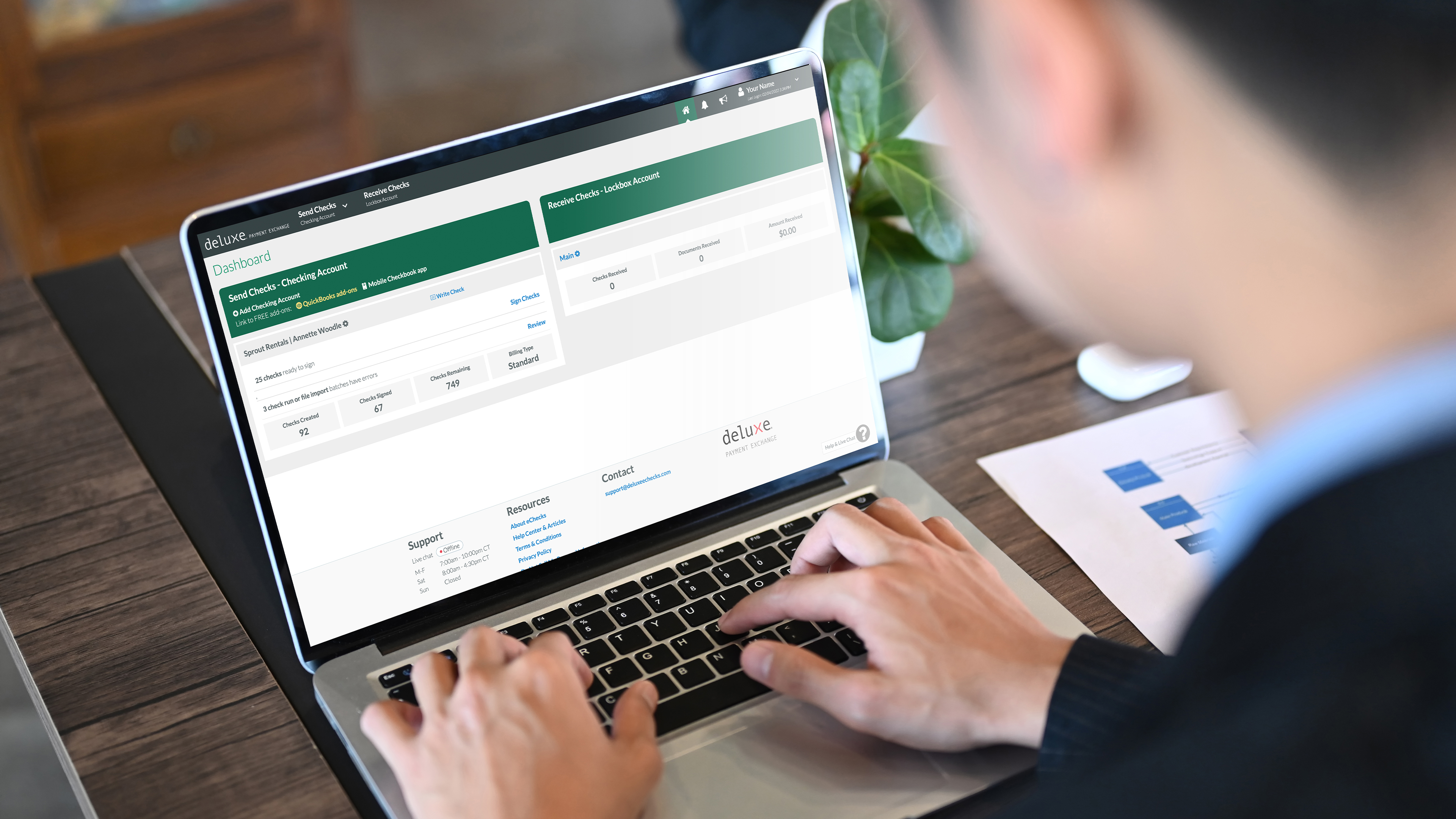 Man using Deluxe Payment Exchange on laptop